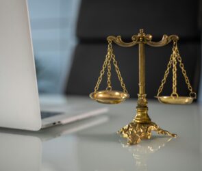 Photo by KATRIN BOLOVTSOVA: https://www.pexels.com/photo/a-golden-balance-scale-beside-a-laptop-6077797/
