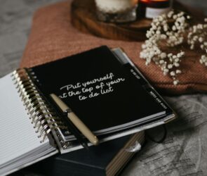 Photo by Polina ⠀: https://www.pexels.com/photo/black-and-white-book-on-brown-textile-5546874/