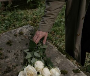 Photo by cottonbro studio: https://www.pexels.com/photo/a-person-placing-white-roses-on-a-concrete-surface-10499701/