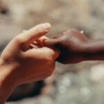 Photo by Kindel Media: https://www.pexels.com/photo/close-up-photo-of-two-people-holding-each-other-s-hands-7978851/